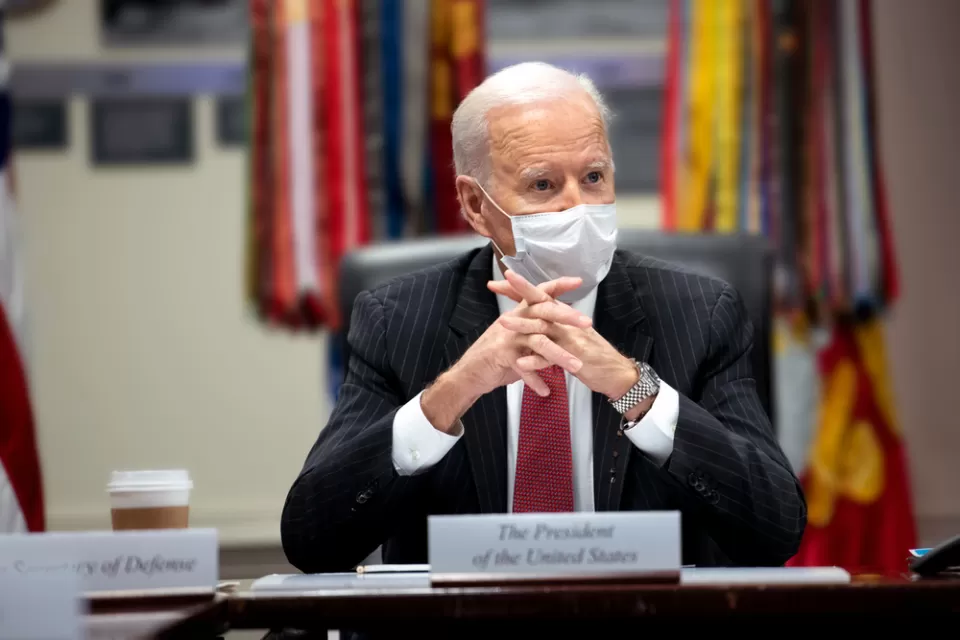 An image of President Joe Biden at a meeting in the White House while wearing a mask in February 2021.